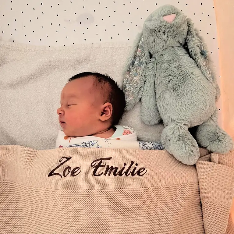 Newborn with their personalised blanket