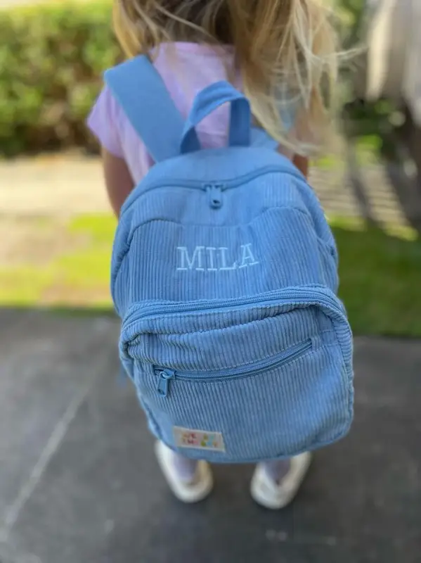 Social image of a happy Weary Theory customer with their new backpack.