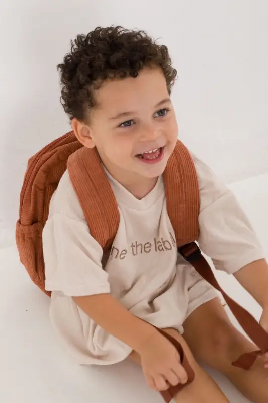 Social image of a happy Weary Theory customer with their new backpack.